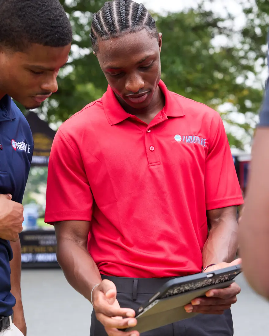 Two team members reviewing the platform together on a tablet at a property.
