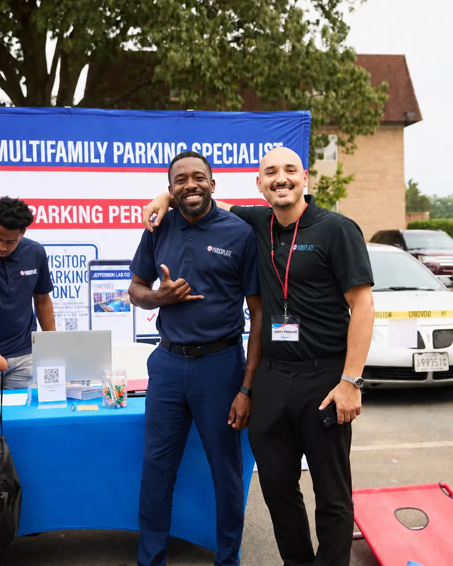 Two team members running a resident sign-up table at a community.